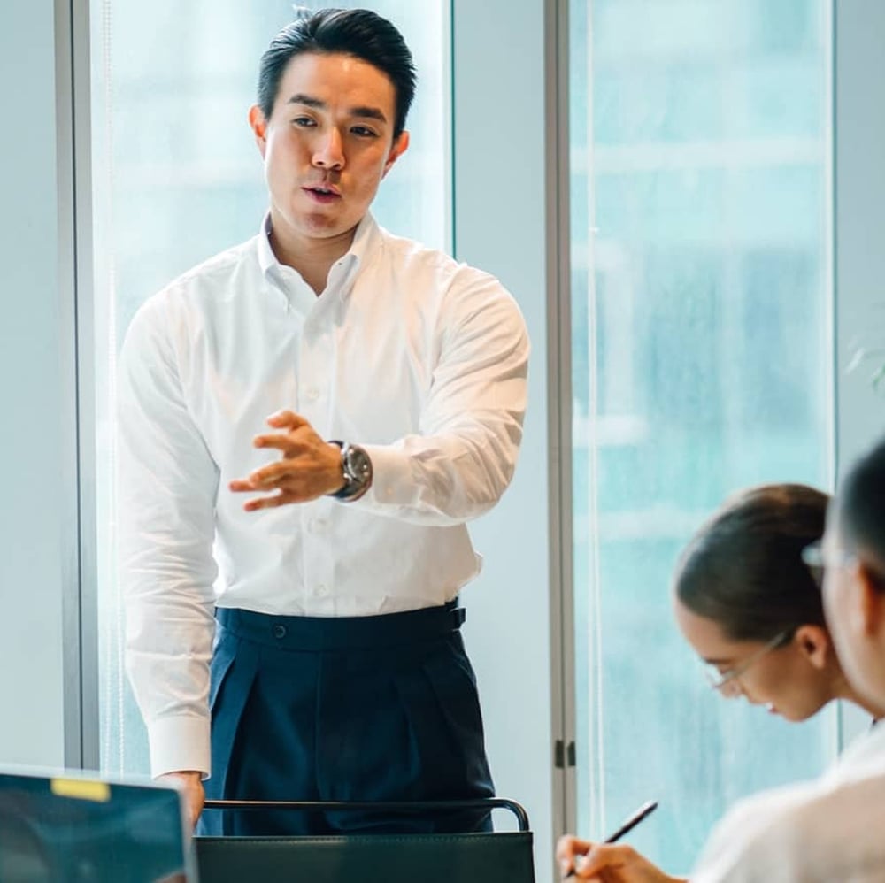 man talking to colleagues in team meeting