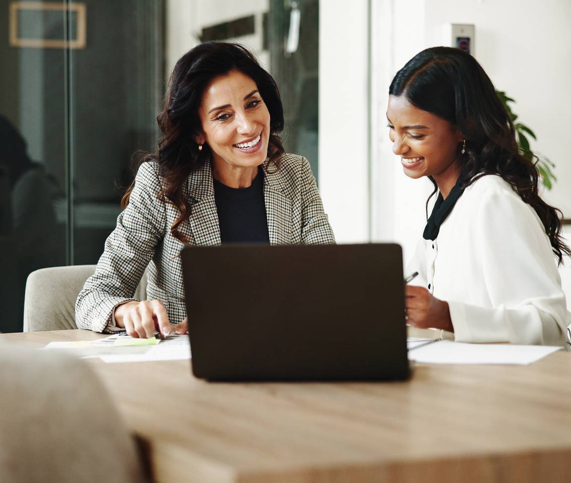 Two business women meeting with laptop and notes-square